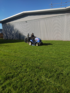 ride on mowing on large grass area
